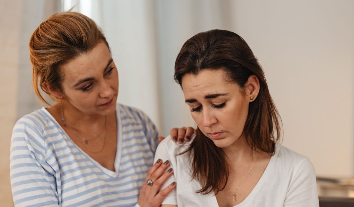 woman supporting her friend who is sad
